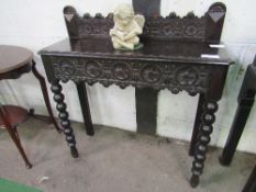 Ebonised hall table, carved frieze drawer on bobbin-turned front legs, 90cms x 31cms x 91cms.