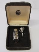 Sterling silver perfume bottle & funnel in a case. Estimate £30-40.