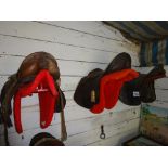 3 leather saddles and racks