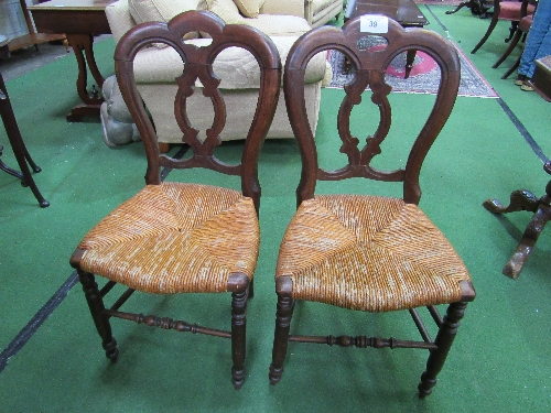 A pair of late Victorian dining chairs with string seats. Estimate £20-30.