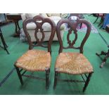 A pair of late Victorian dining chairs with string seats. Estimate £20-30.