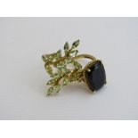 2 gold overlay on silver rings, dark stone & green flower, size Q & R. Estimate £20-40.