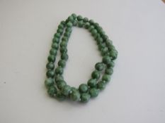 Natural jade bead necklace (hand knotted). Estimate £250-350.