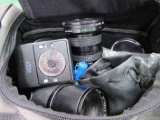 Canvas bag containing Soligor lens, Canon lens & a qty of filters. Estimate £30-50.