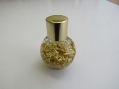 Small jar of 22ct gold leaf. Estimate £20-30.