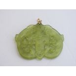 Oriental jade coloured carved hard stone pendant. Estimate £40-60.