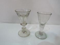 An 18th century illusion glass or Toastmaster's glass & a faceted Georgian toasting glass.