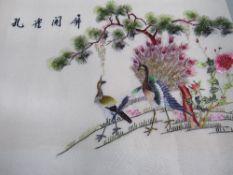 Chinese silk embroidery depicting a peacock & a peahen, very bright colours & in good condition.