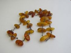 Amber coloured necklace. Estimate £50-60.