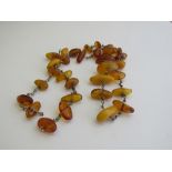 Amber coloured necklace. Estimate £50-60.