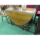 Oak gate leg table on barley twist legs, 135cms (open) x 92cms. Estimate £20-40.