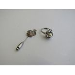 Stick pin decorated with galleon & a white metal & pearl ring, size O. Estimate £10-20.