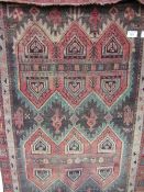 Persian rug with Aztec design, 2.2m x 118cms. Estimate £20-30.
