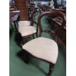 8 mahogany balloon-back dining chairs with upholstered seats. Estimate £150-200.