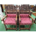 2 oak open armchairs with highly ornate carved backs depicting animals, figures, scrolls (known as