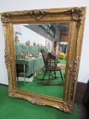 Very large decorative gilt framed bevel edge wall mirror, 160cms x 130cms. Estimate £200-250.