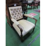 Cream button back nursing chair on castors. Estimate £20-40.