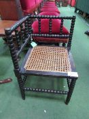 19th century bobbin turned corner chair with bergere seat. Estimate £40-50.