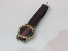 Gucci quartz gold plated wristwatch with colour coded strap, good working order. Estimate £15-20.