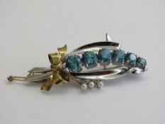 9ct yellow & white gold brooch, mounted with 6 Zurcons, length 5.5cms, weight 10.9gms. Estimate £