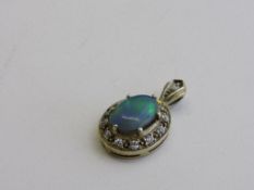 Opal & white sapphire yellow metal pendant, size of pendant 2.5mm. Estimate £150-180.