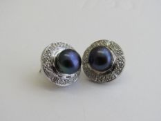 Pair of white metal, black pearl & diamond earrings. Estimate £30-40.