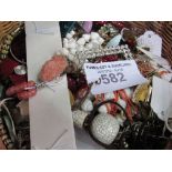 A basket containing costume jewellery. Estimate £15-20.