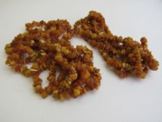 2 tumbled amber necklaces, 1x approx 150gms & 1x 190gms. Estimate £20-30.