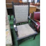 Ebonised open armchair. Estimate £25-35.