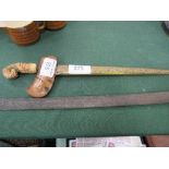 Kris dagger with highly carved handle, together with a German cavalry sabre.