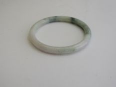 Small jade bangle. Estimate £20-30.