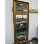 Gilt framed bevel edge wall mirror, 135cms x 50cms. Estimate £30-50.