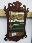 Small Chippendale style mahogany wall mirror with inlaid shell motif, bevelled glass. Estimate £30-