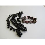 A braid & jet bead necklace & a bracelet of coloured glass & red beads. Estimate £20-30.
