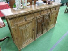 Oak sideboard with carved door, 3 frieze drawers over 3 cupboards, 160cms x 39cms x 86cms.