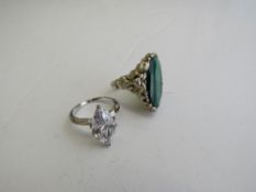 Silver & green stone ring & a silver oval white stone ring. Estimate £10-20.