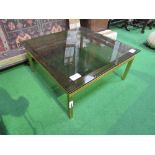Gold coloured metal coffee table with smoked glass top by Pierre Vandel, Paris.