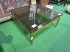 Gold coloured metal coffee table with smoked glass top by Pierre Vandel, Paris.