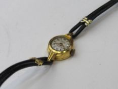 Swiss-made gold plated lady's wrist watch with leather strap. Estimate £20-30.