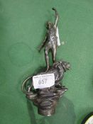 Metal statuette of a person standing on a lion. Estimate £10-20.