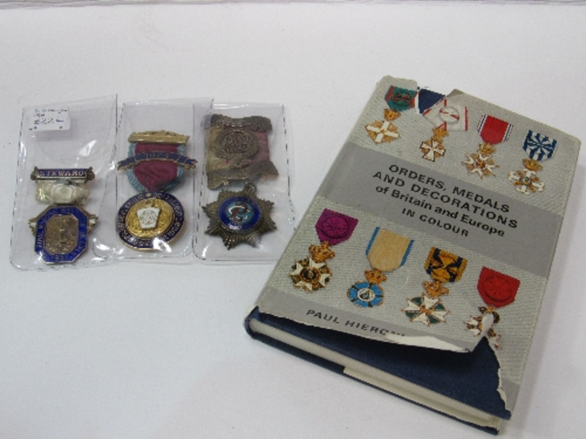 3 sterling silver Masonic medals together with a book on European Orders, medals & decorations.