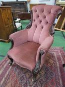 Victorian pink upholstered carved nursing chair on castors. Estimate £30-60.