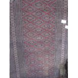 Persian rug with geometric patter, 1.6m x 0.96cms. Estimate £20-30.