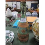 Large antique Delamain & Co cognac bottle with its original label. Estimate £25-40.