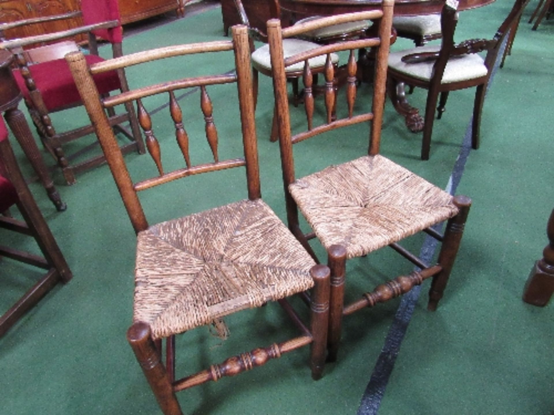 2 oak framed ladder back dining chairs with string seats. Estimate £10-20