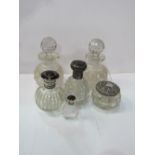 2 cut glass decanters, height 15cms, 3 glass centre bottles & a silver topped glass powder jar.