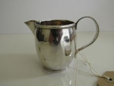 Hallmarked silver milk jug, London 1924 (a few small dents), weight 3.2oz. Estimate £25-35.