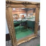 Very large decorative gilt framed bevel edge wall mirror.