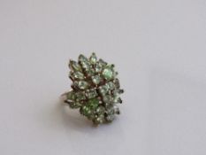 Gold over silver peridot large cluster cocktail ring, size O. Estimate £20-30.