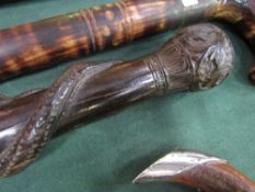 Carved African ebony tribal stick, carved snake eating a lizard. Estimate £15-20